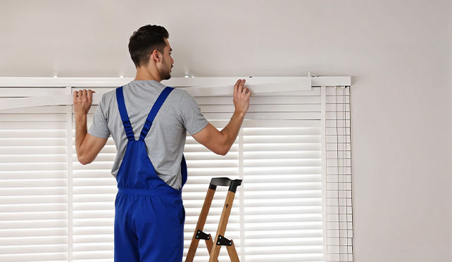 man installing blinds securely