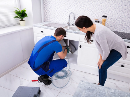 man fixing drain problems of a sink