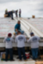 RF Lusa & Sons Sheetmetal Men at Work on Metal Roof