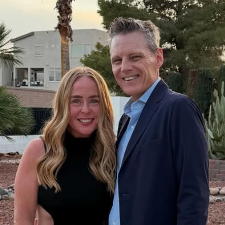 Susan and Ken, hosts at The Austoria, smiling together outdoors