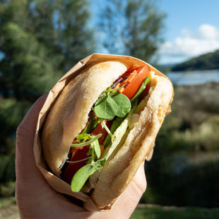 Salad roll at Lagom Bakery with the Burrill Lake view in the background