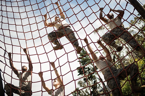Military-soldiers-climbing-rope-during-o