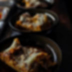 Two bowls of Divino Enoteca's famous home cooked lasagna alla bolognese