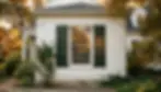 Colonial home exterior with raised panel shutters at golden hour, showing exterior shutter installation on coastal facade