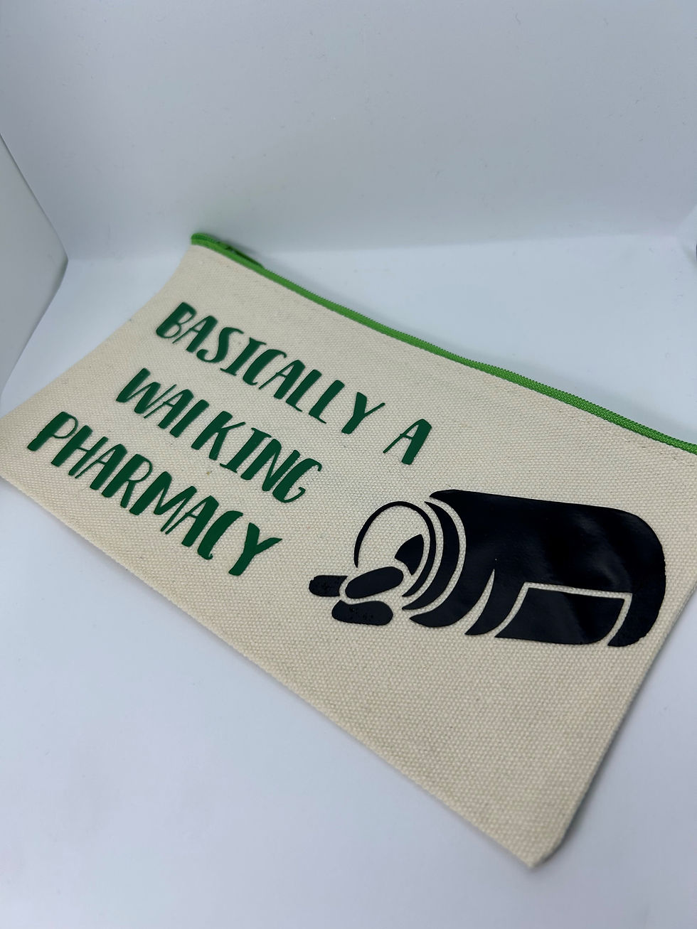 Thumbnail: cream zip pouch with green writing walking Pharmacy