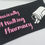 Thumbnail: black zip pouch with pink writing walking Pharmacy
