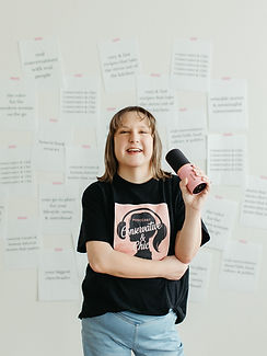 Nicole Cleveland, host of the Conservative & Chic podcast, holding a pink microphone
