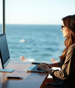 A realistic photo of the side profile of brunette women working remotely with ocean in the