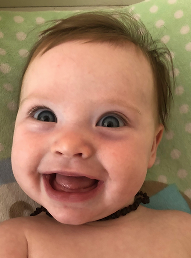 Joyful baby with a wide smile and bright eyes