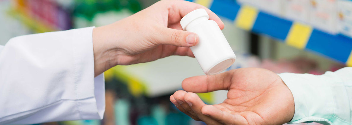 Pharmacist hands giving prescription