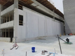 Thermacrete sound wall under construction around parking garage