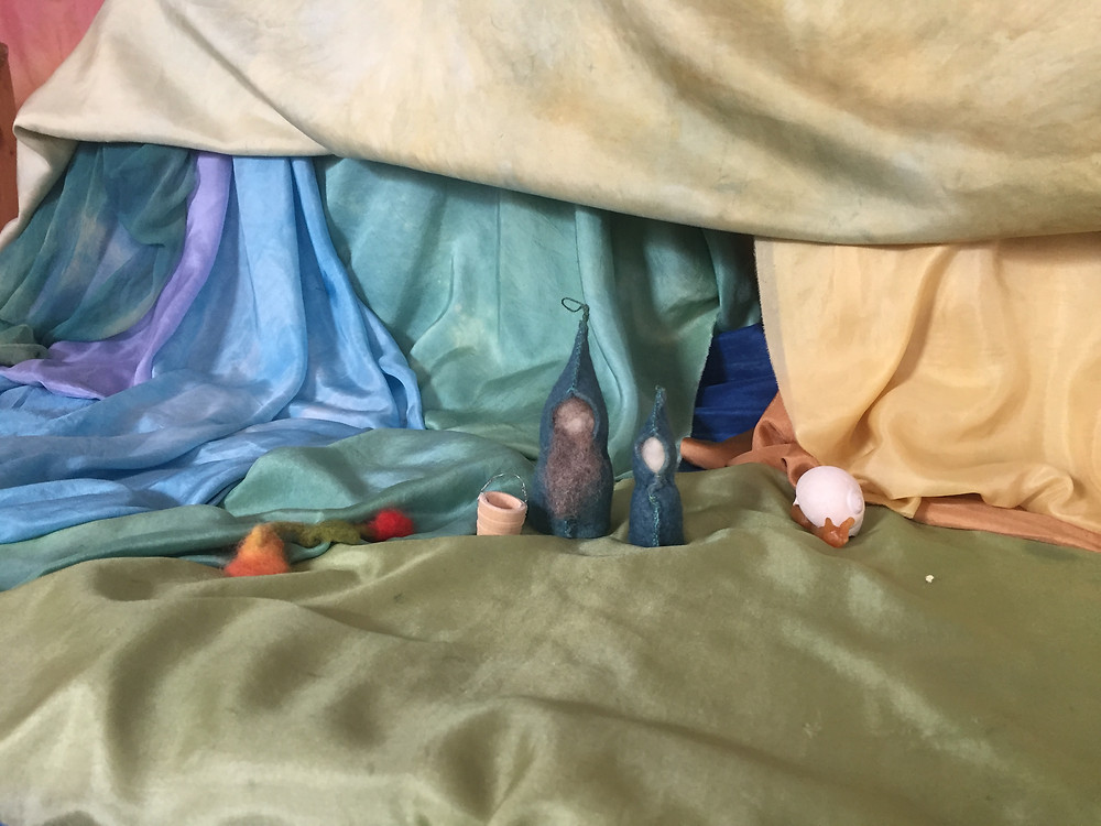 Play scene with silk scarves and gnome figures