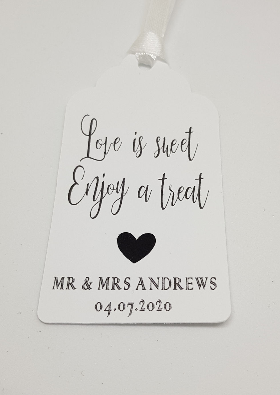 Thumbnail: Love is Sweet, Enjoy a Treat Tag with ribbon and a black heart. Your Names and Wedding Date are at the bottom.