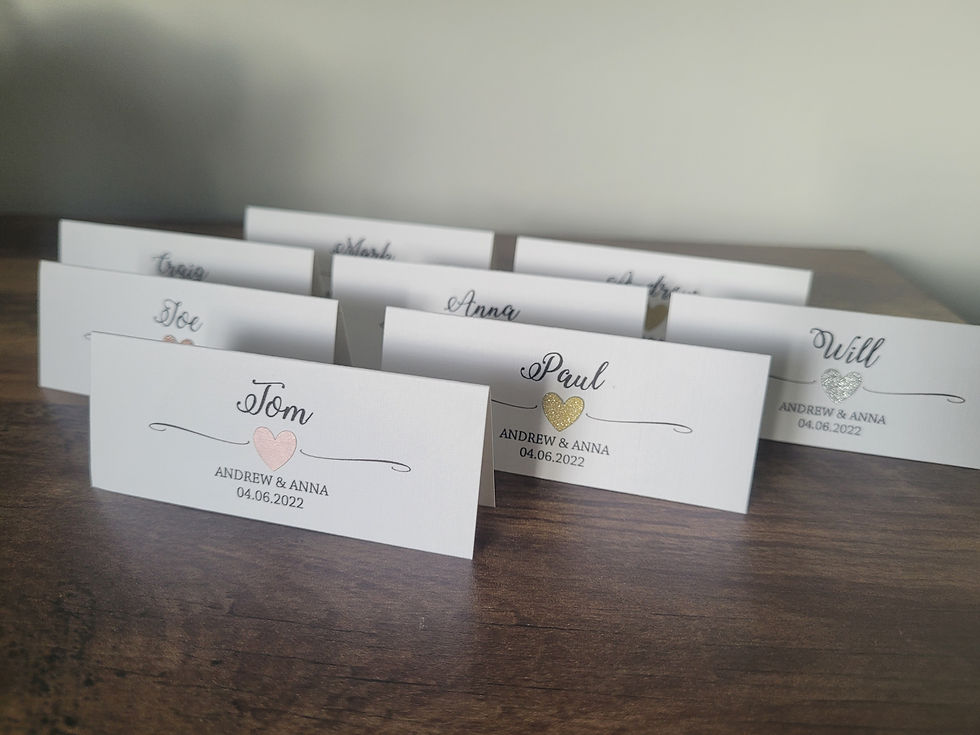 Thumbnail: Heart design table name place cards printed on white card. Your guest name, your names and wedding date are printed on each.