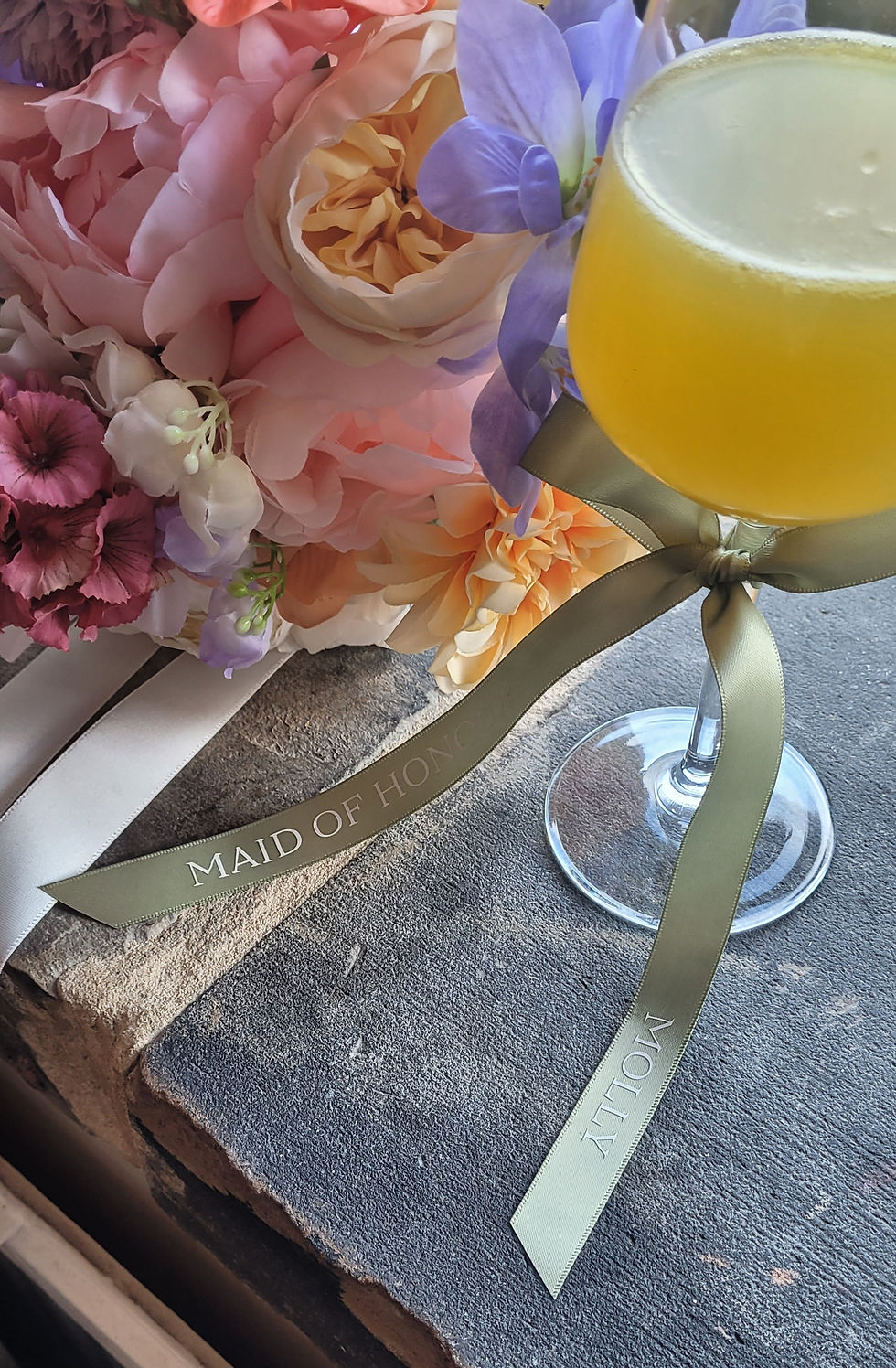 This image shows the personalised satin ribbon in Sage Green with the name in White.