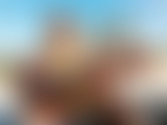 young happy man playing guitar on the beach