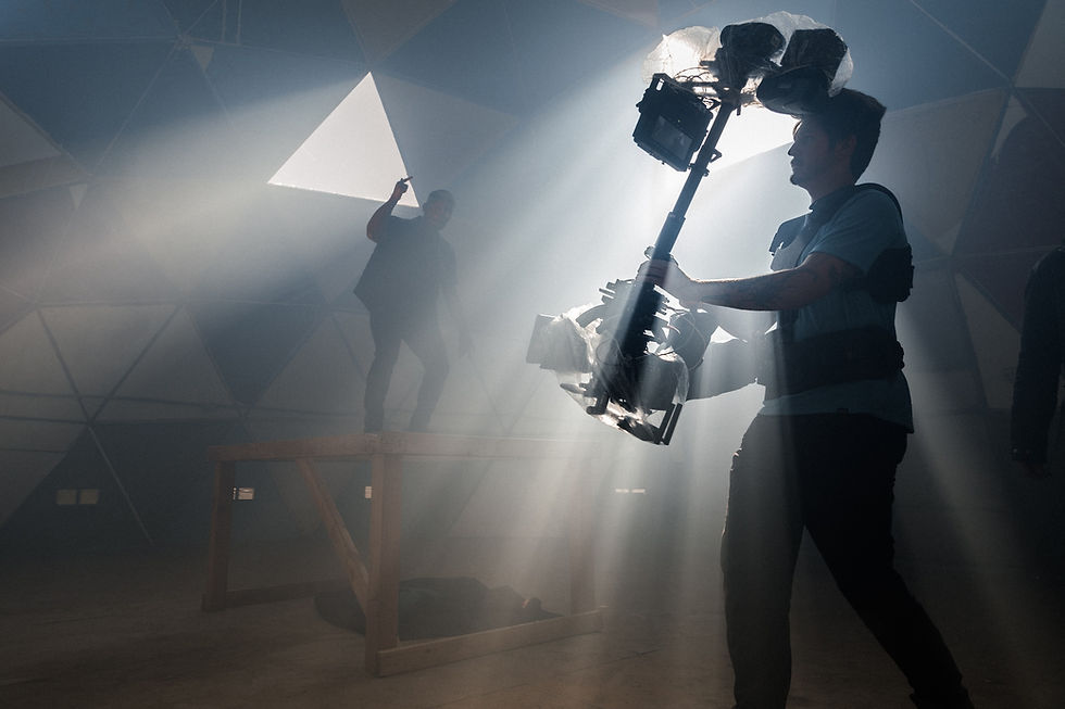 a man is filming a another man in a smoky room