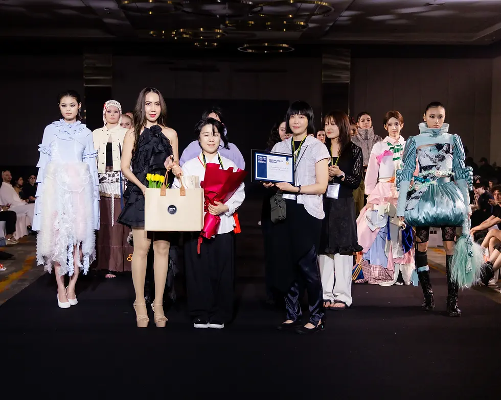 Team Chungkang College of Cultural Industries designer proudly receives a Certificate of Honour from Thailand Fashion Week