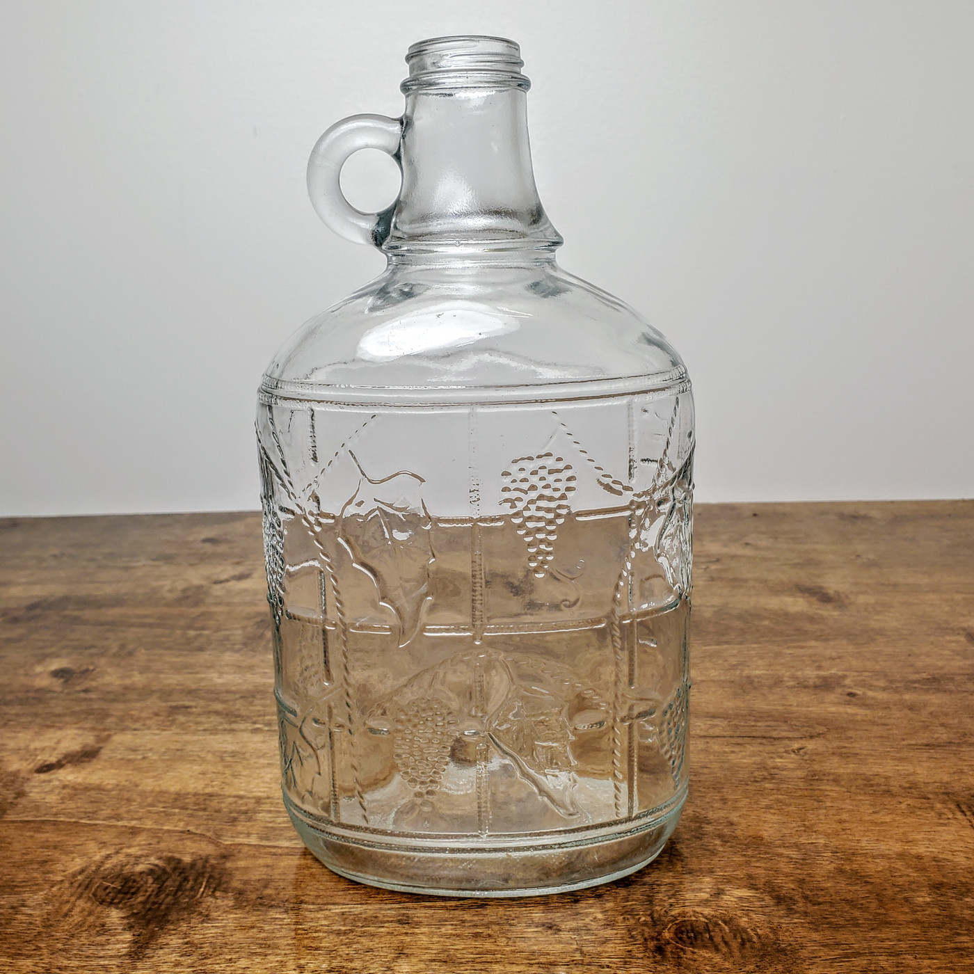 Vintage Ball half gallon glass wine decanter bottle with embossed grape design.