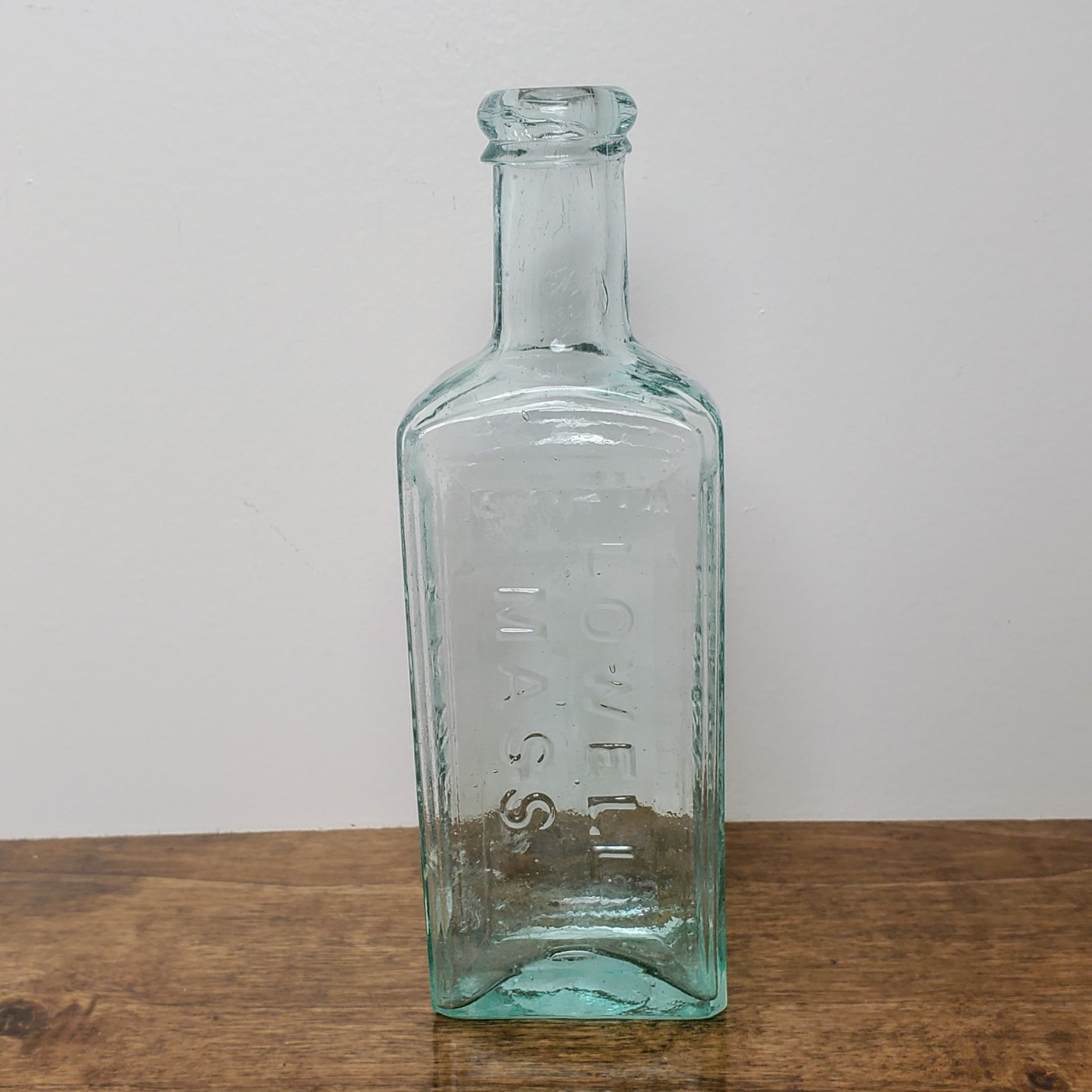 Antique aqua medicine bottle embossed with Ayers Ague Cure Lowell Mass.