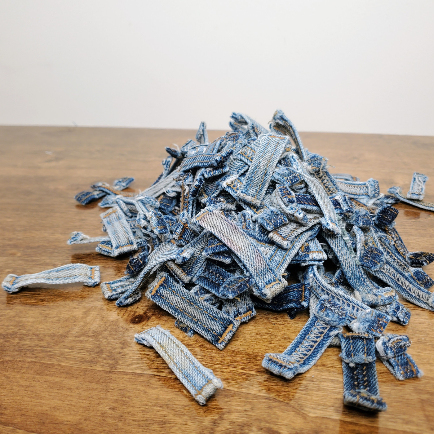 Upcycled blue denim belt loops in various indigo washes for rustic DIY projects.