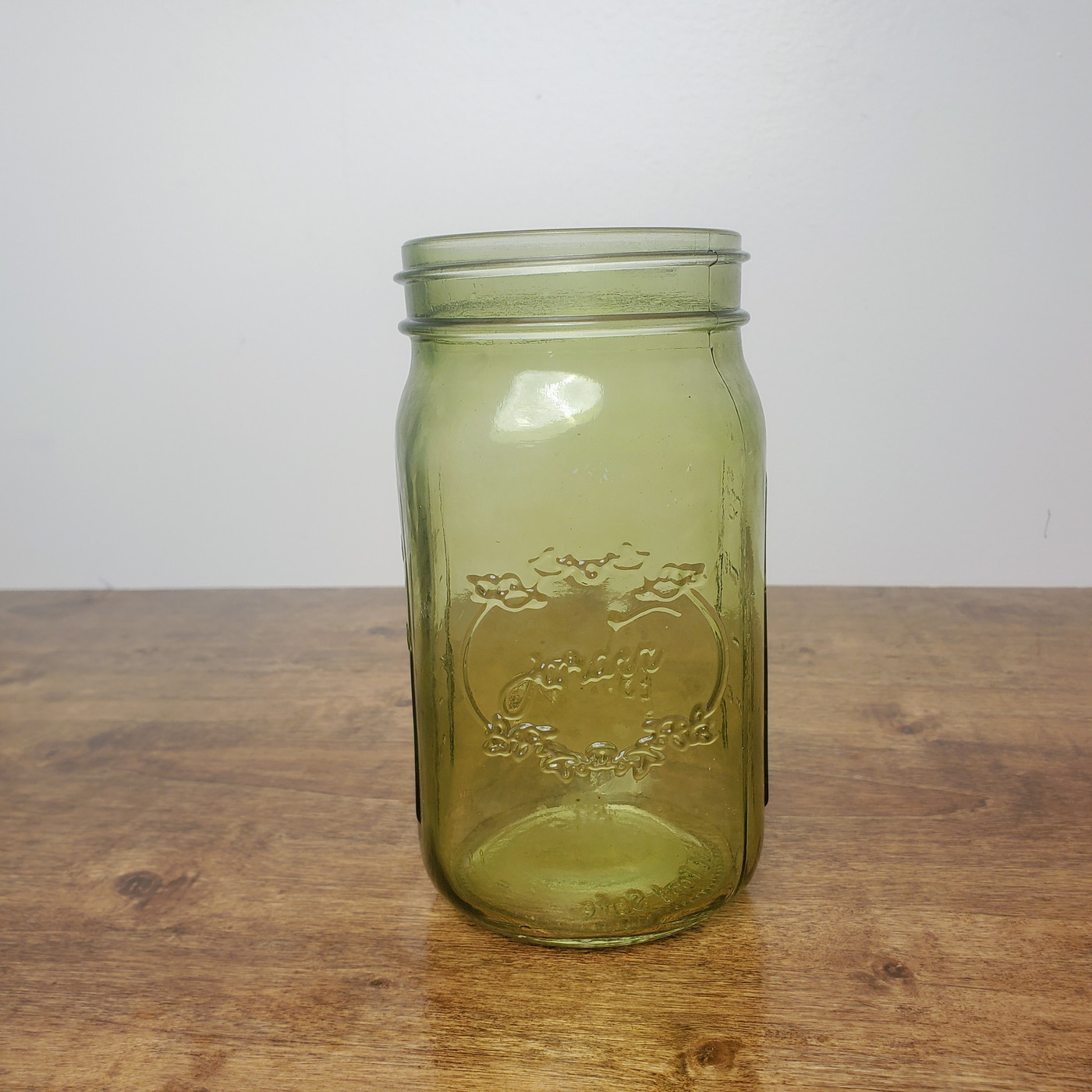 A vintage Jardin Green embossed mason jar quart size decorative vase from 1946.