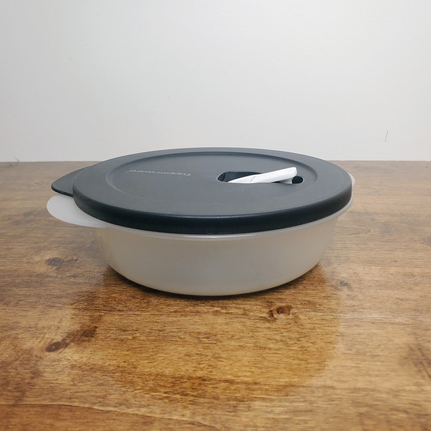 Tupperware CrystalWave 4.25 Cup Round Microwave Bowl with black vented lid.