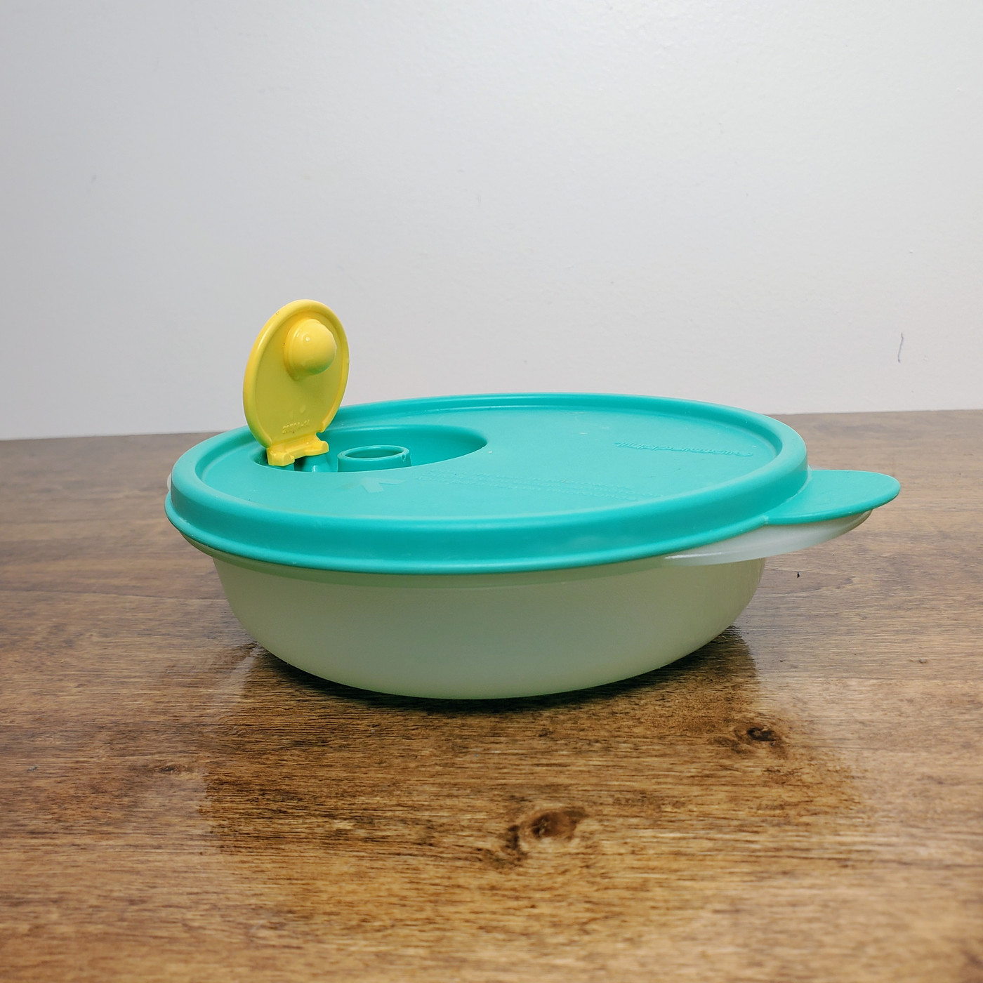 Tupperware CrystalWave Heat in Bowl with teal steam release lid.
