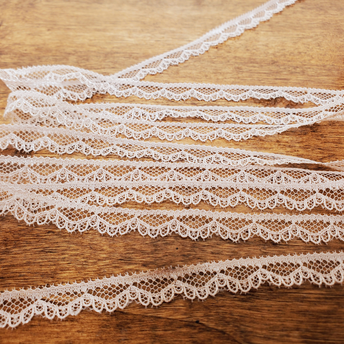 Soft beige lace trim ribbon measuring ten yards for decorative sewing and crafts.