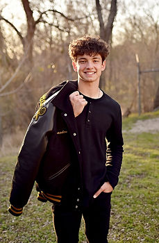 Senior boy posing with his letterman jacket during a session photography session Gulfport, MS