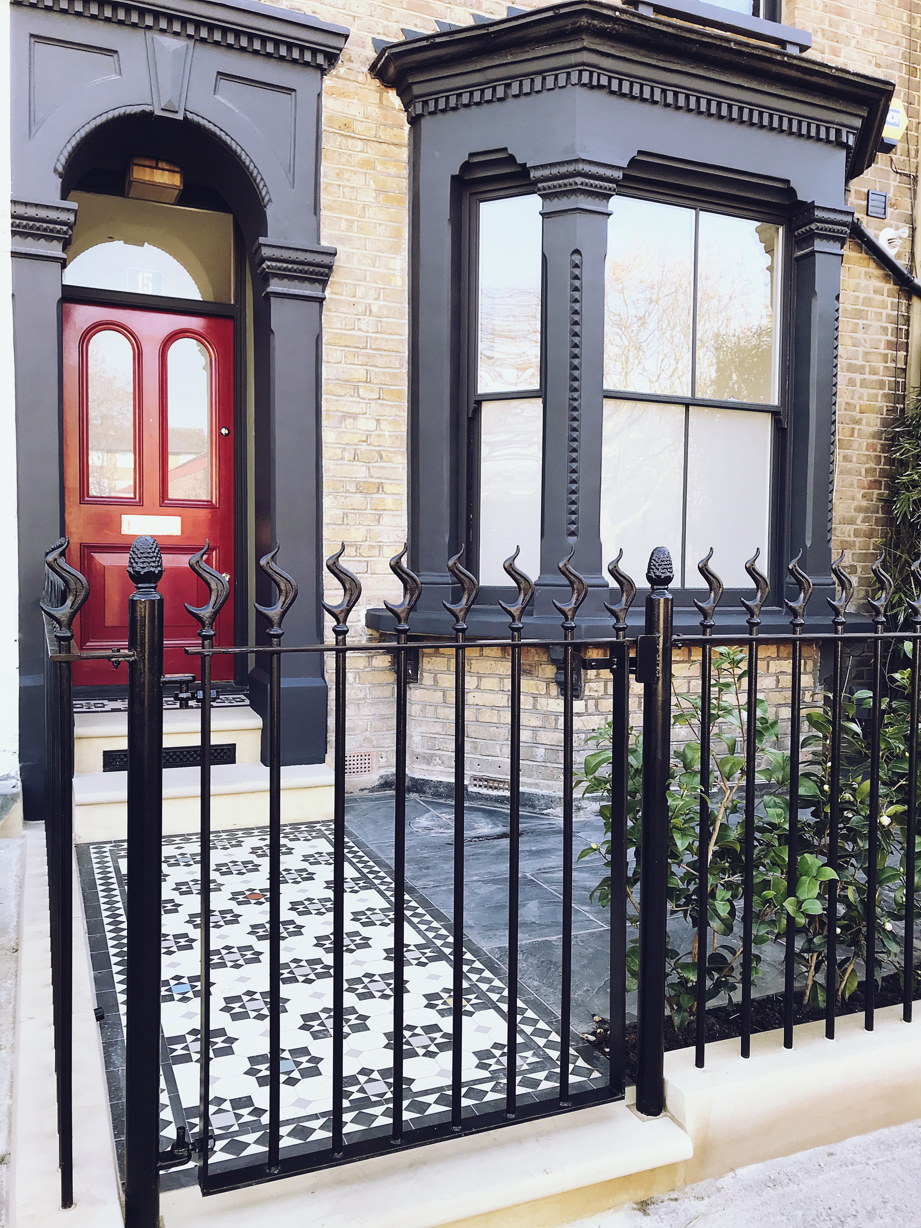 Victorian restoration with modern twist drilled rails and gate with flame finial