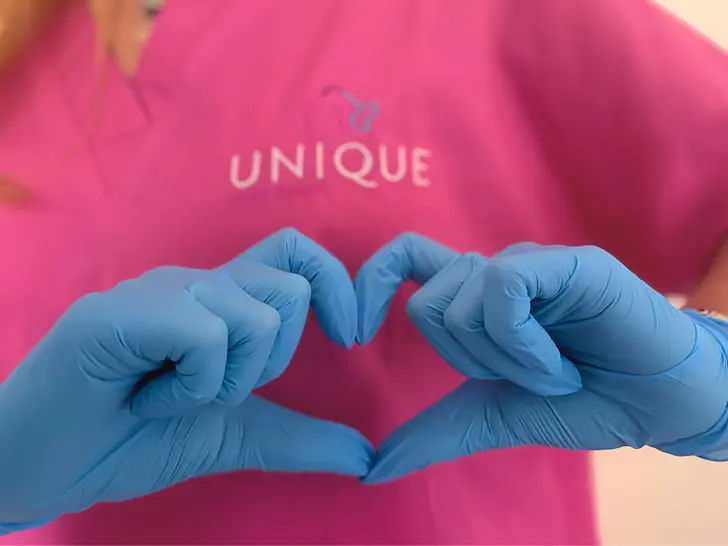 Unique home care assistant giving heart hand gesture