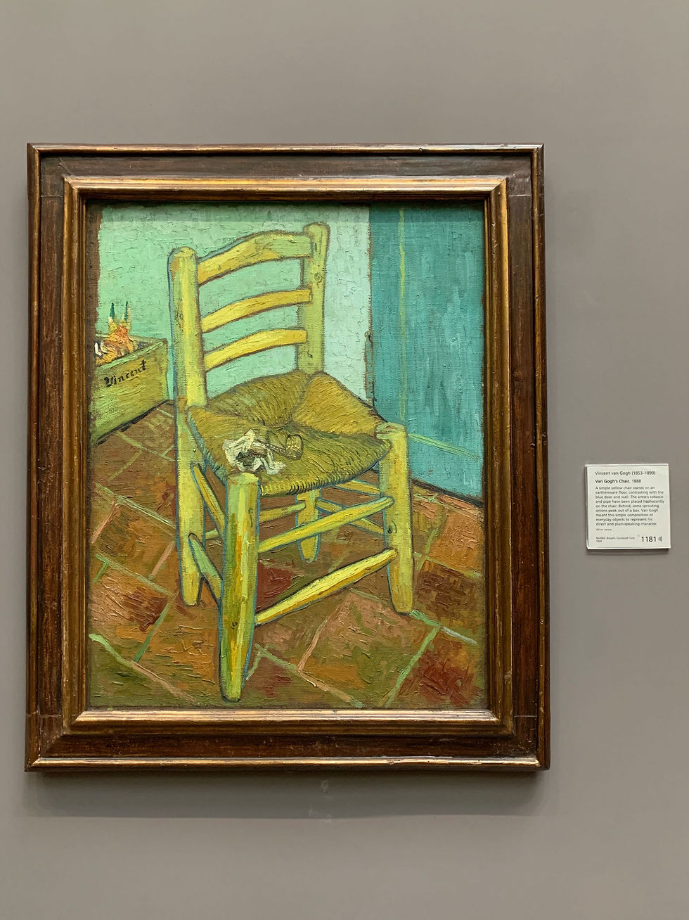 A simple yellow chair stands on an earthenware floor, contrasting with the blue door and wall. The artist's tobacco and pipe have been placed haphazardly on the chair. Behind, some sprouting onions peek out of a box. Van Gogh meant this simple composition of everyday objects to represent his direct and plain-speaking character.