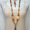 Thumbnail: Orange yellow flat stones, brown tassel, wood beads