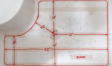 Shower floor with measurements marked to demonstrate how to measure for a CoreSeal insert