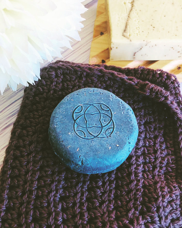 Thumbnail: Ylang Ylang  solid shampoo bar sitting on cotton charcoal crochet washer, natural eco-friendly hair care product