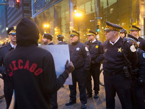 Protester in front of a group of police officers