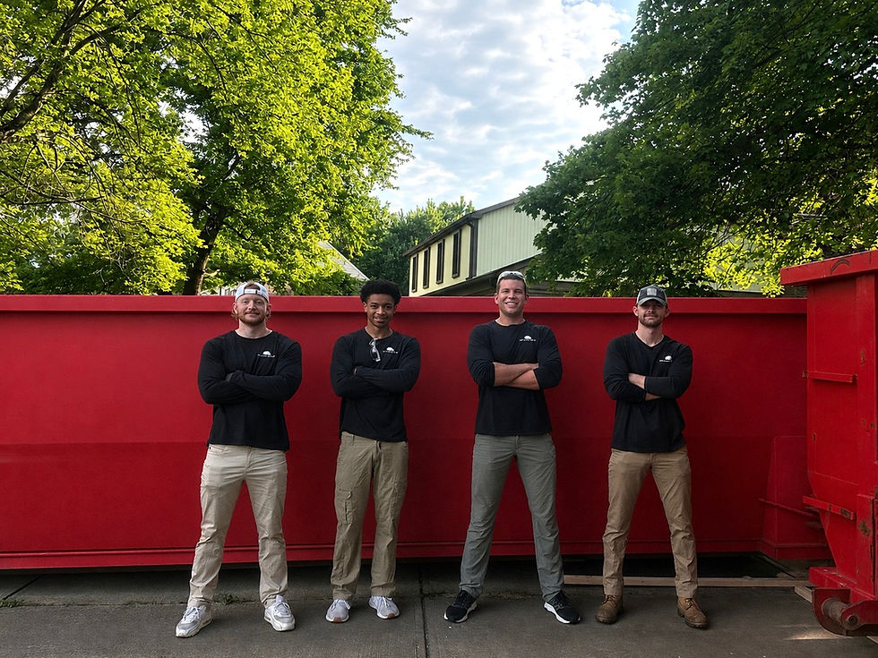 indiana movers standing in front of dumpster from hoarder house