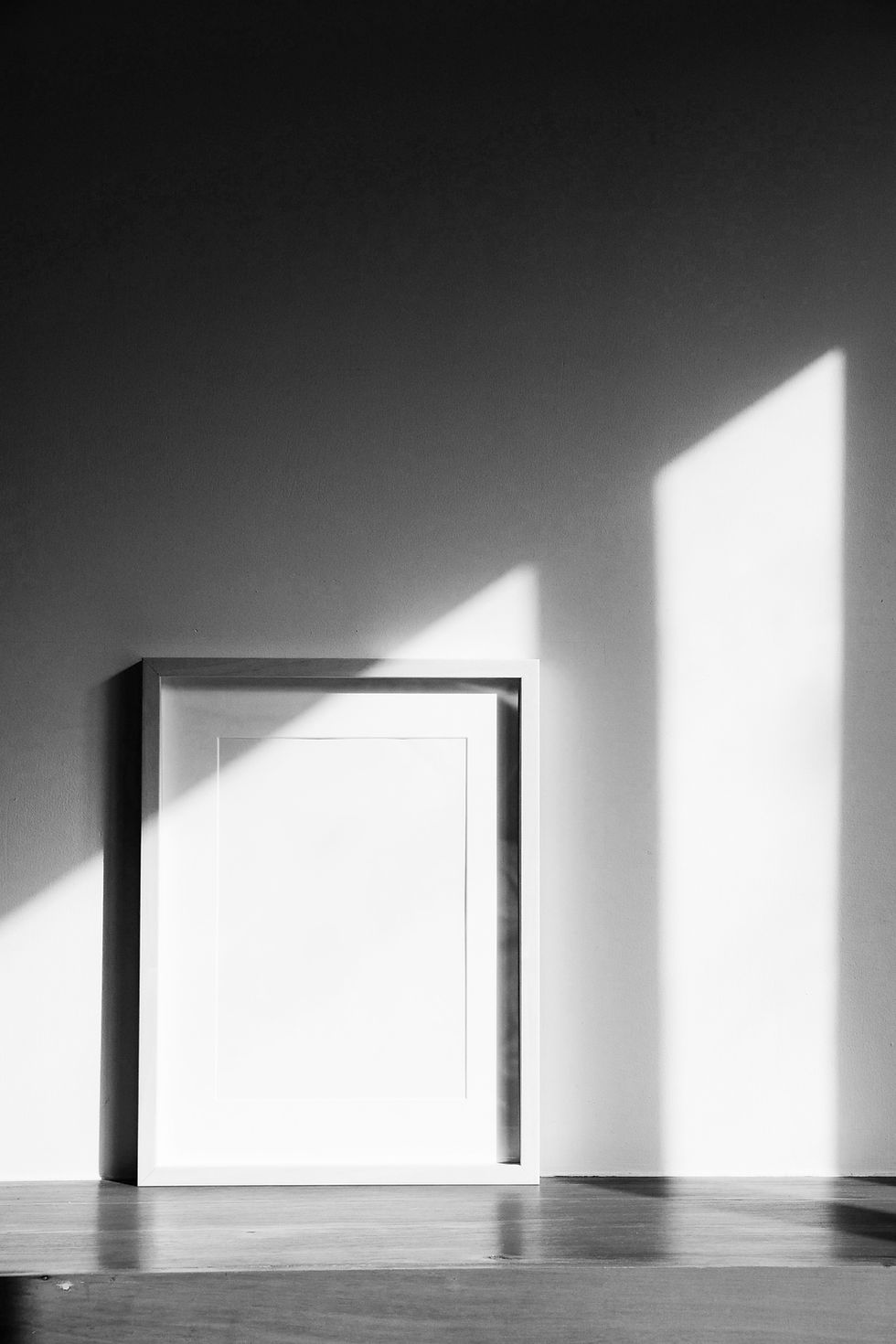 Black-and-white framed canvas with sharp light and shadow, representing the clarity and structure of visual identity design.