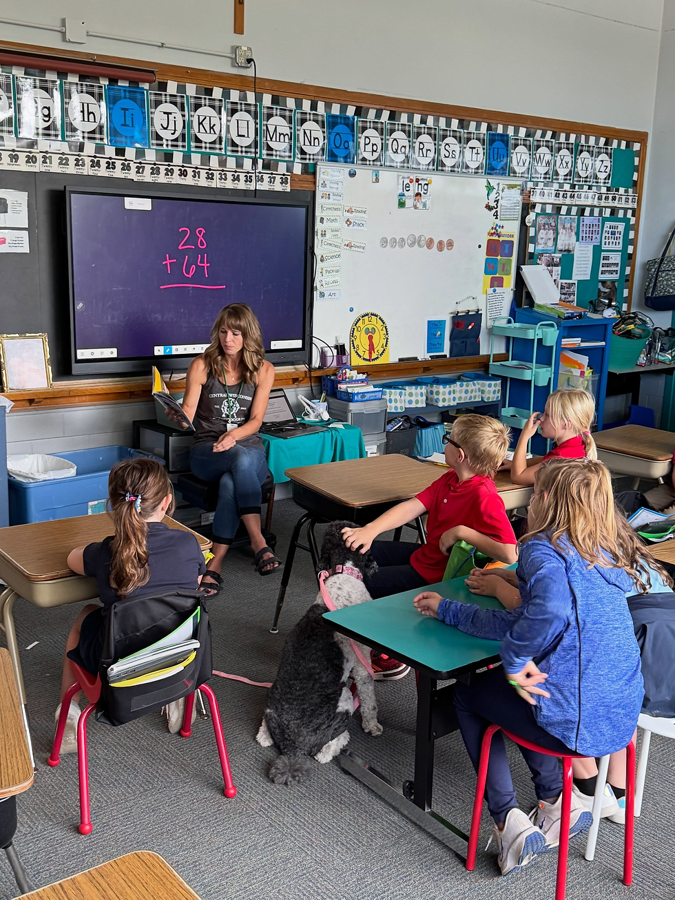 Maggie returns to work in a classroom, calmly visiting students as Jess reads to the group.