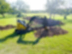 john deere mini excavator digging drain field lines for a conventional septic system in texas