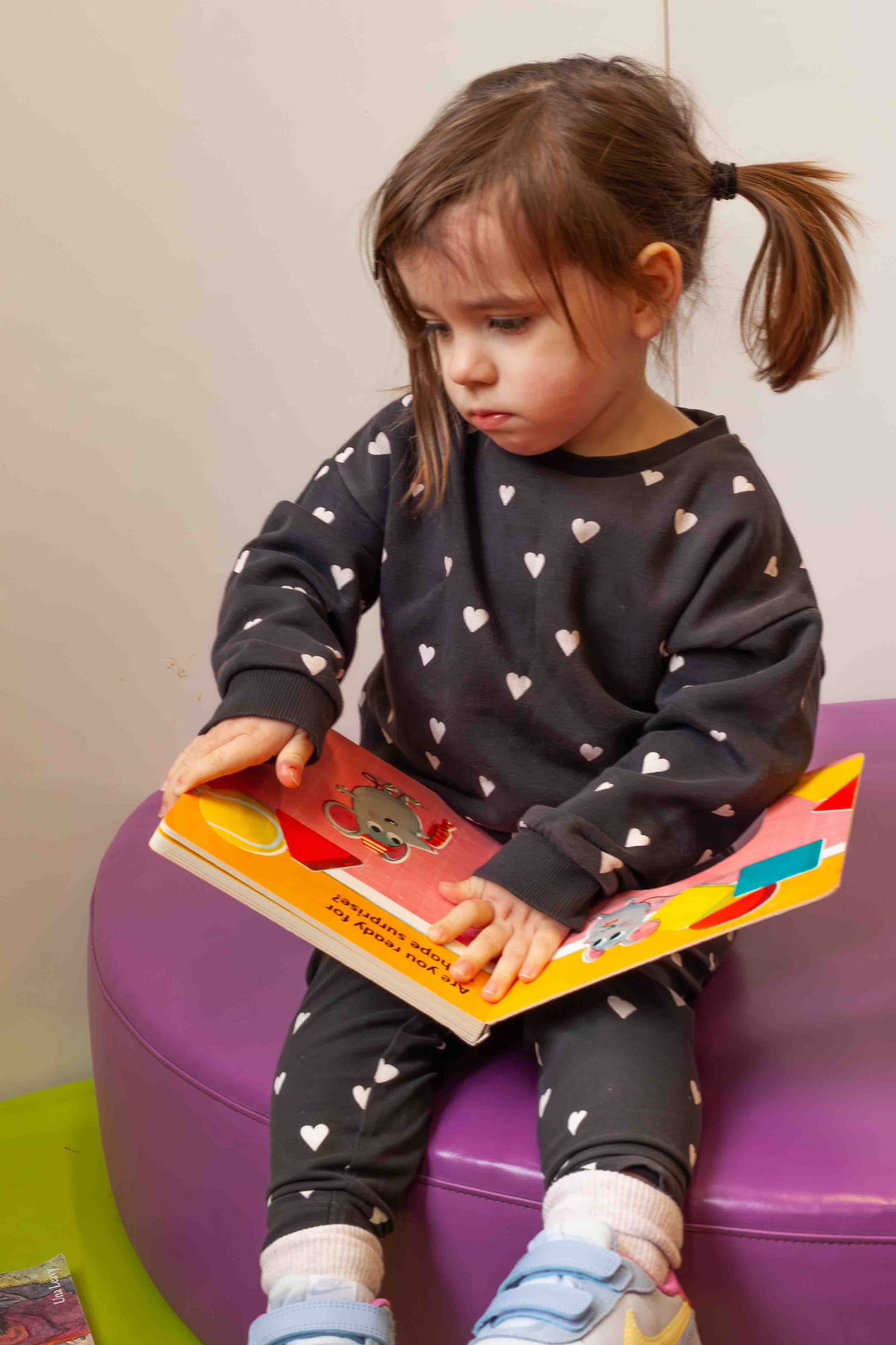 little girl reading a book