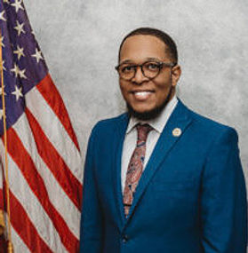 A professional head shot photo of District 1 Commissioner Jarrod Fletcher