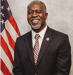 A professional head shot photo of the Chairman for the Board of Commissioners, Ryran Traylor