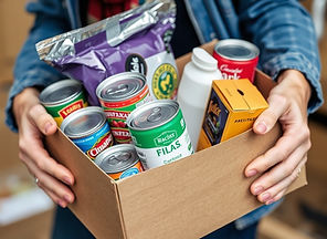 a close up of someone carrying a box of canned goods and non perishable food items in thei