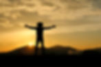 Man wore hat outstretched arms at beautiful sunset..jpg