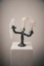 A ceramic handmade whimsical candelabra with dripping candles