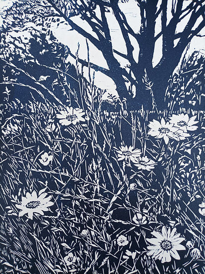 Dark blue print of flowers and trees on white paper