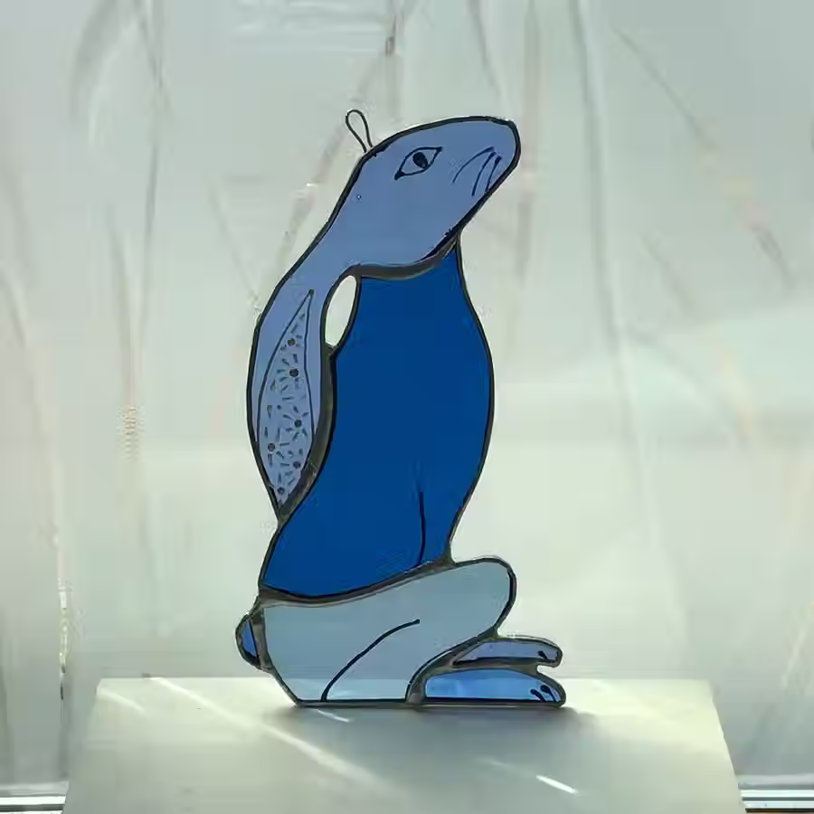 Thumbnail: Blue stained glass hare with light background