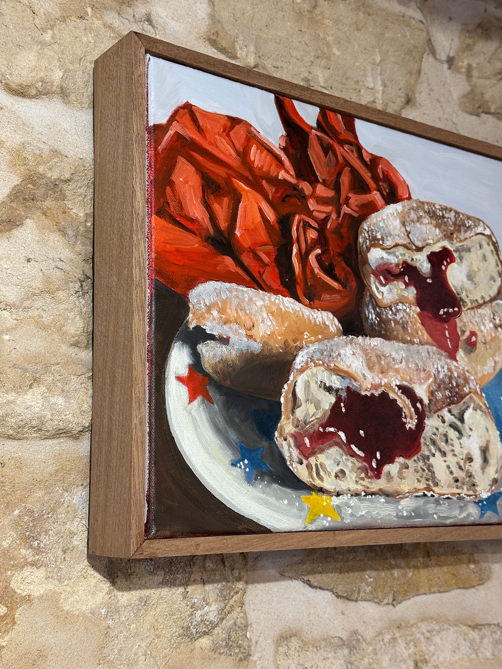 Thumbnail: Painting of two jam doughnuts on a plate with jam oozing out with wood frame on a stone wall.